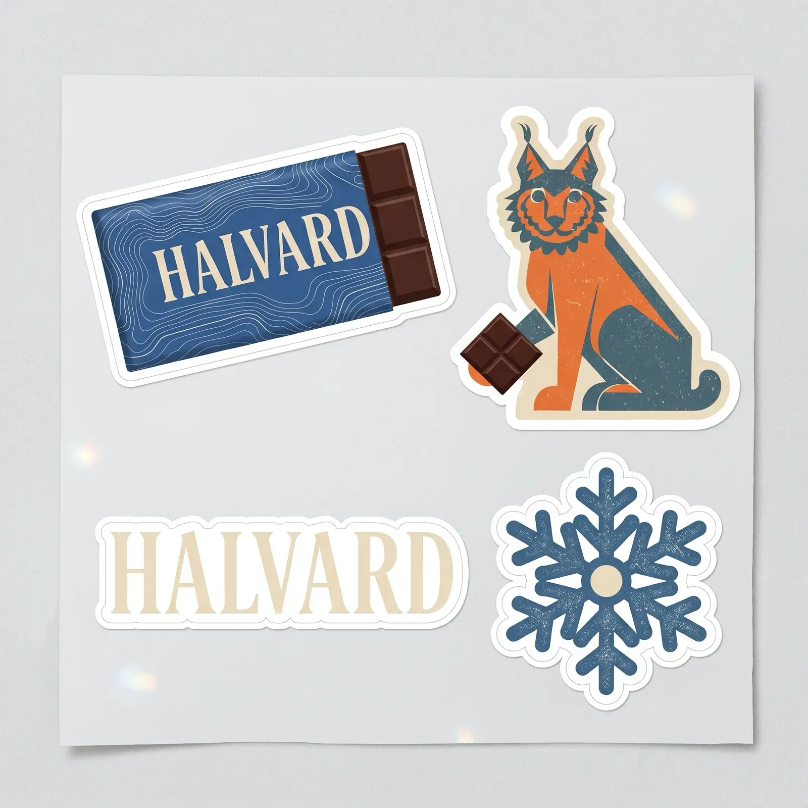 A sheet of four die-cut stickers on light grey: the cobalt Halvard bar, an orange and teal lynx holding a square of chocolate, the HALVARD wordmark in cream, and a blue snowflake.