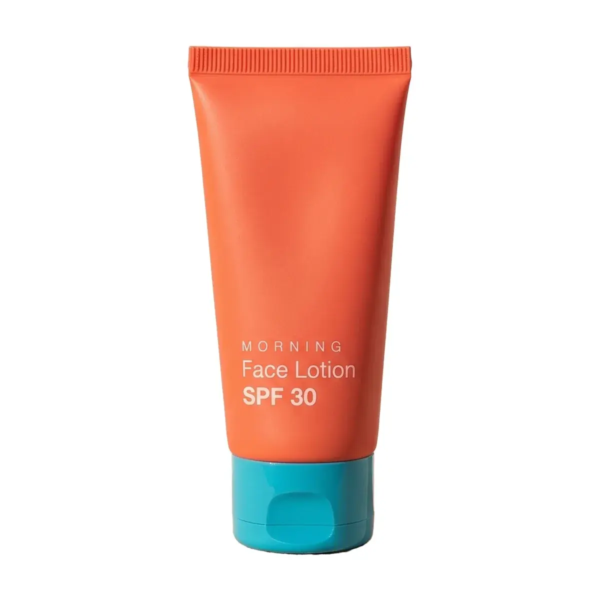 The orange face lotion tube cut out of the ledge photo and placed on pure white