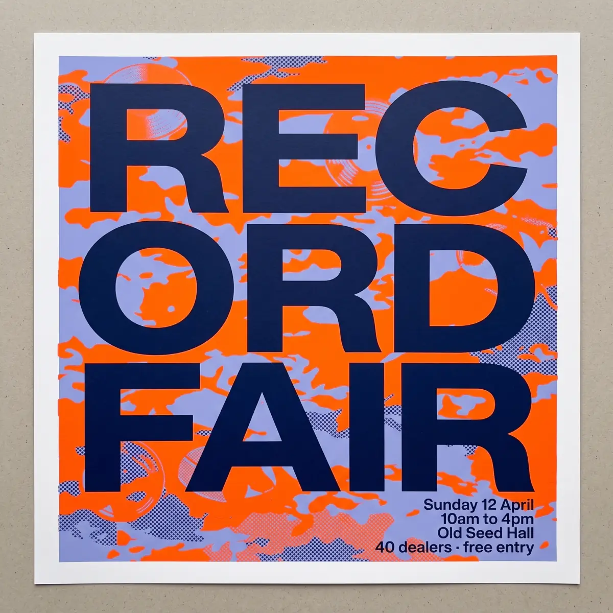 Nano Banana 2.1: REC, ORD and FAIR in navy over an orange and lavender camouflage inside a white border, the sheet lying on a grey board
