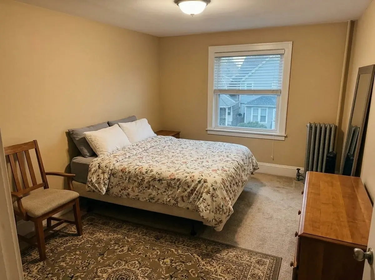 The same bedroom decluttered by AI: the bed made with its floral duvet, the chair, rug and dresser clear, and the nightstand removed