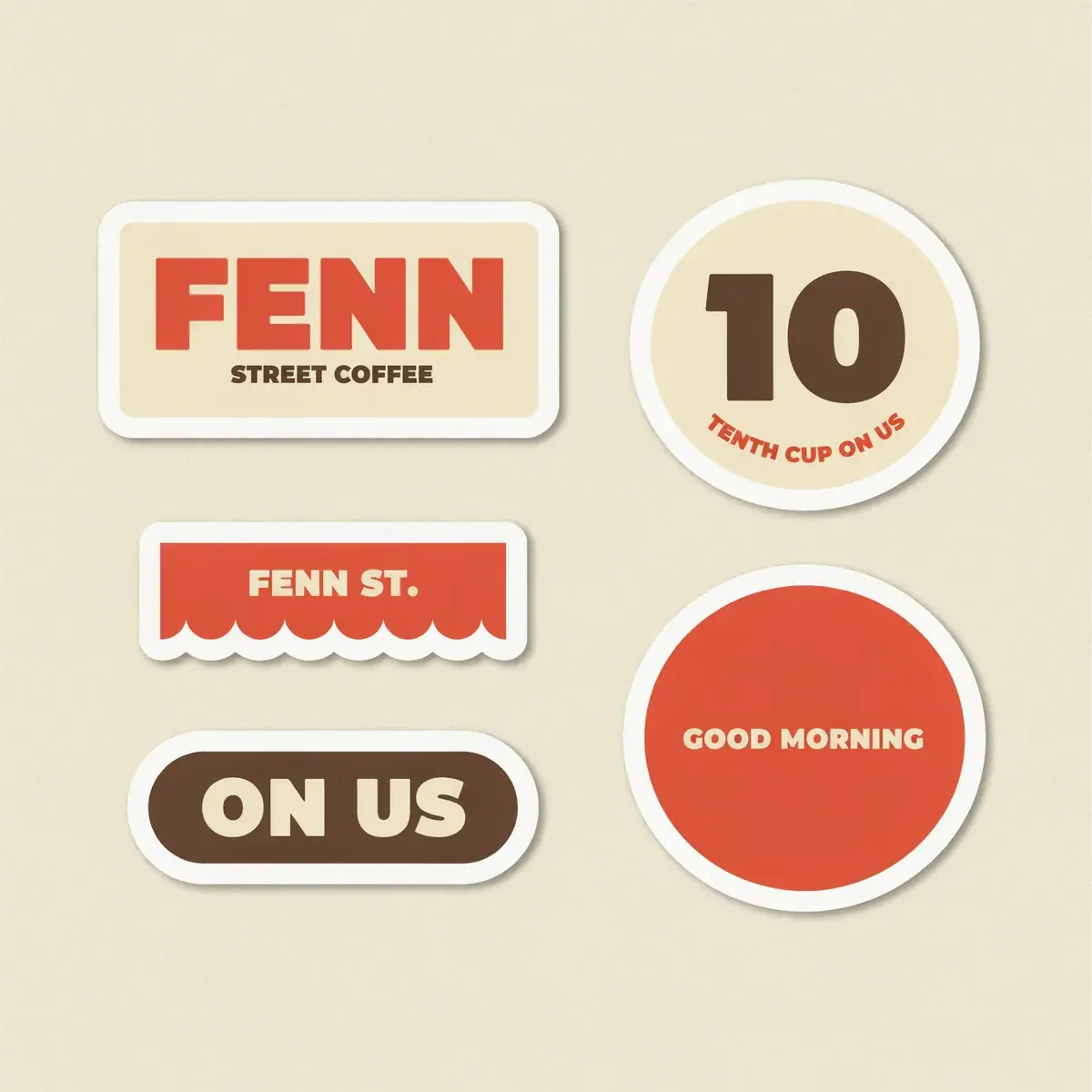 A Fenn Street Coffee sticker sheet in tomato red, espresso brown and cream on an oat backing sheet: FENN over STREET COFFEE, a huge 10 with TENTH CUP ON US, a scalloped awning edge reading FENN ST., an ON US pill and a red GOOD MORNING circle